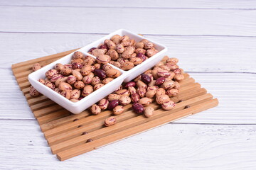 Natural bean grains, Phaseolus vulgaris on wooden background with light veins