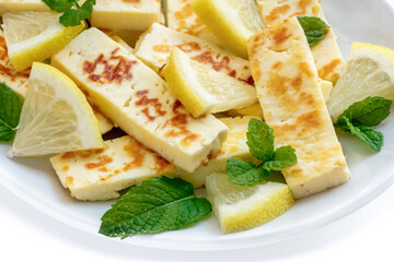 Grilled Halloumi with Lemon and Mint on White Plate Side View