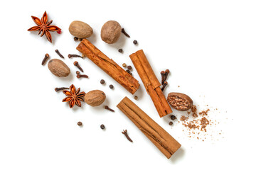 Cinnamon Sticks Nutmeg Star Anise Cloves Peppercorns over White Top View - Powered by Adobe