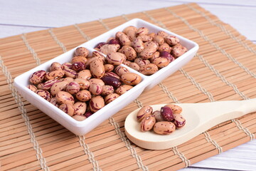 Natural bean grains, Phaseolus vulgaris on wooden background with light veins
