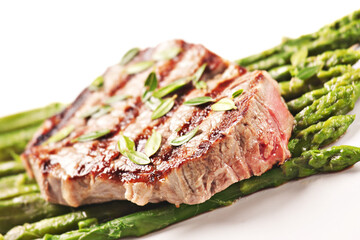 Fillet of beef with asparagus on a plate.