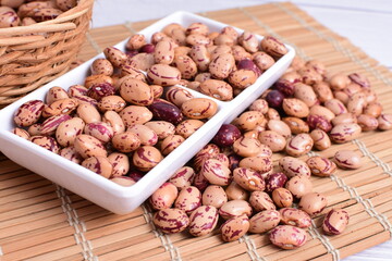Natural bean grains, Phaseolus vulgaris on wooden background with light veins