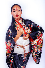 young pretty geisha in black kimono with sakura, asian ethno closeup on white background isolated