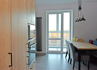 Fragment of the kitchen with access to the loggia. Modern minimalism