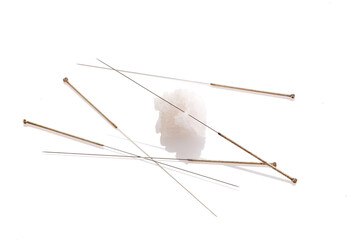 Silver needles for traditional Chinese acupuncture medicine. White background. There is some free space for your text or sign.