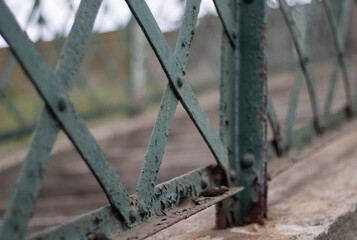 Close up photo of an old rusty iron fence of a concrete  stairs