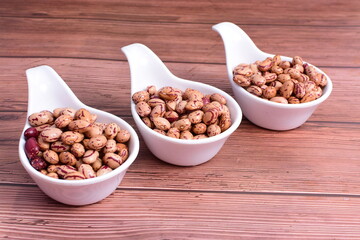 Natural bean grains
Phaseolus vulgaris on dark grain wood background
