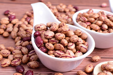 Natural bean grains
Phaseolus vulgaris on dark grain wood background