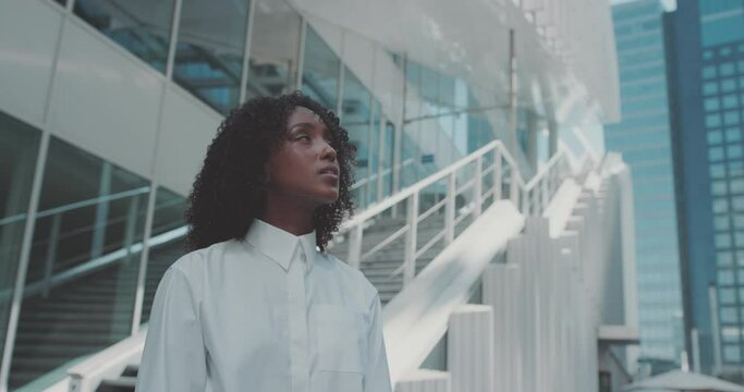 Woman With Confident And Dreamer Look Looks At Modern Skyscrapers