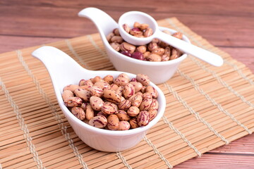 Natural bean grains
Phaseolus vulgaris on dark grain wood background