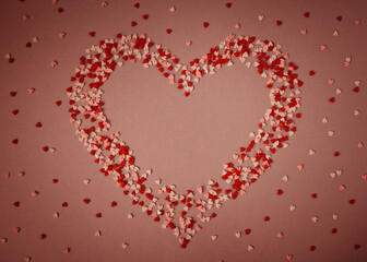 heart, a symbol of love on a red background with small hearts
