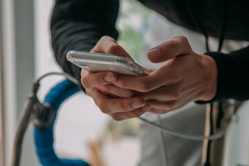 hands with mobile phone on the bicycle