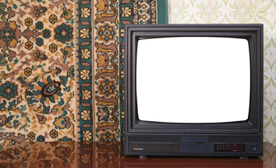 Old black vintage TV with white screen to add new images to the screen TV set against wallpaper and carpet from 1980-1990.
