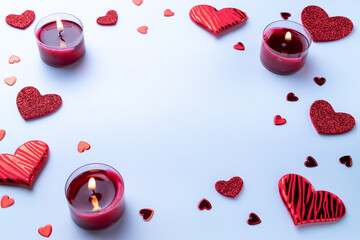 Valentine day composition: red love hearts, romantic gift box, candle on white background. February romance present card.