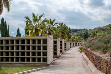 Obraz premium View of the famous Malaga Park Cemetery with graves and crypts, decorated with bouquets of flowers