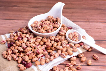 Natural bean grains
Phaseolus vulgaris on dark grain wood background
