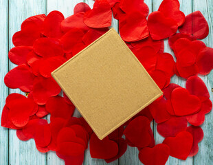 Valentines gift box with copy space. Cardboard laying on the small paper hearts.