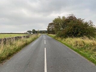 Looking along, Broad Dubb Road, with heavy rain clouds above in, Norwood, Harrogate, UK