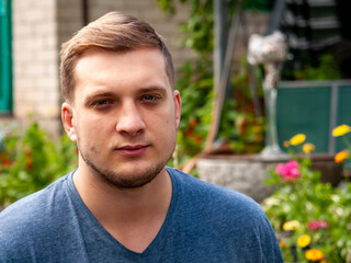 Portrait of an unshaven man resting in park.