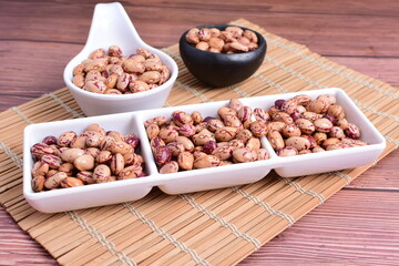 Natural bean grains
Phaseolus vulgaris on dark grain wood background