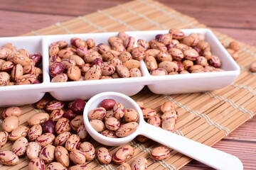 Natural bean grains
Phaseolus vulgaris on dark grain wood background