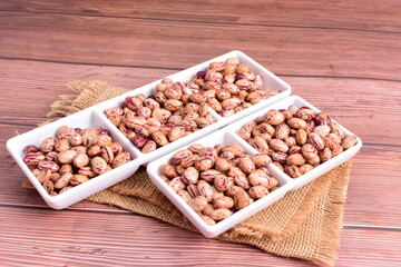 Natural bean grains
Phaseolus vulgaris on dark grain wood background