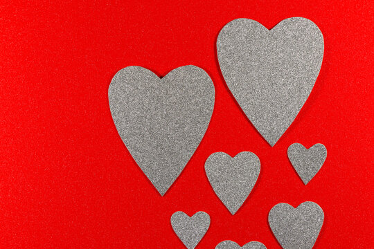 Silver Hearts Rising On Red Textured Background