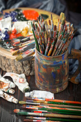 Brushes and paints for painting on an old background.
