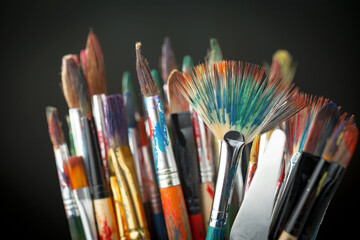 Paint brushes with drawings on an old background