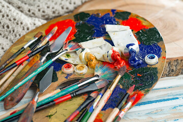 Brushes and paints for painting on an old background.