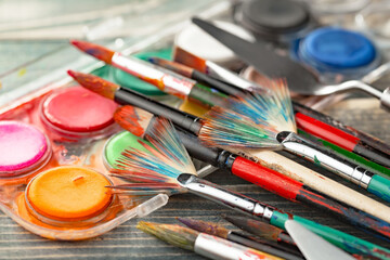 Brushes and paints for painting on an old background.