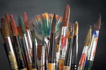 Fototapeta premium Multi-colored oil paints squeezed out of a tube onto a white sheet of paper.