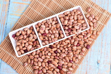 
Natural bean grains
Phaseolus vulgaris on blue grain wood background