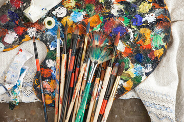 Brushes and paints for painting on an old background.