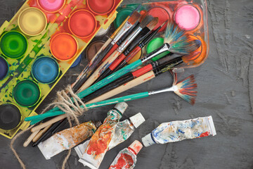 Brushes and paints for painting on an old background.