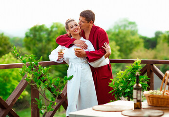 happy and in love, a man and a woman, in housecoats, walking in the courtyard of the hotel, on a romantic day