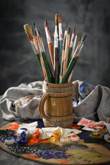 Brushes and paints for painting on an old background.