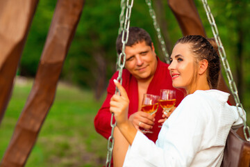 happy and in love, a man and a woman, in housecoats, walking in the courtyard of the hotel, on a romantic day