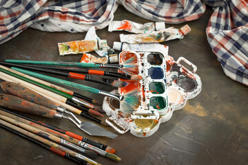 Multi-colored oil paints squeezed out of a tube onto a white sheet of paper.