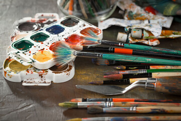 Obraz premium Multi-colored oil paints squeezed out of a tube onto a white sheet of paper.