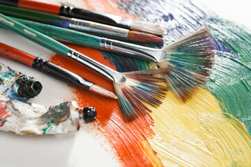 Brushes and paints for painting on an old background.