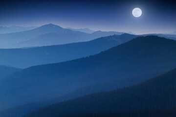 Bright Full  Moon Rises Over Hazy Colorado Rocky Mountain Range