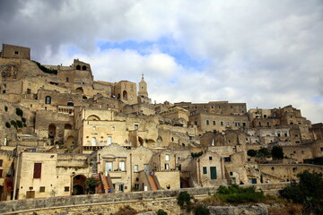 Fototapeta na wymiar Cloudy blue sky over the structures of the houses of Sasso Barisano of Matera, European Capital of Culture 2019