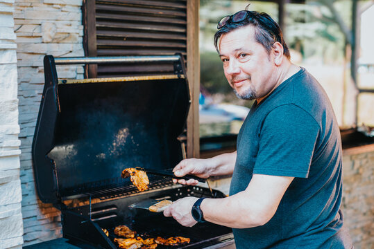 Middle-aged Caucasian man preparing barbeque