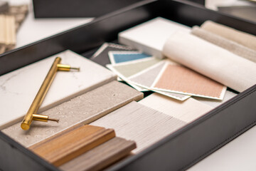 Interior designer's working table, an architectural plan of the house, a color palette, furniture...