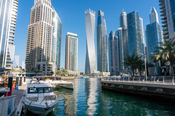 Obraz na płótnie Canvas Yachts near Embarkment in Dubai Marina. Modern buildings in Dubai, UAE. In the city of artificial channel length of 3 kilometers along the Persian Gulf