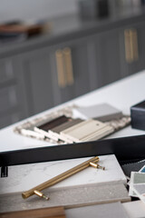 Interior designer's working table, an architectural plan of the house, a color palette, furniture and fabric samples. Drawings and plans for house decoration.