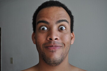 Mixed Race man stubbled face expression surprised