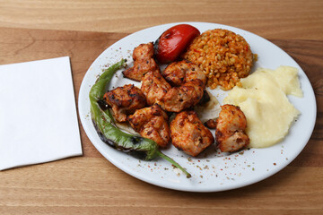 Chicken shish kebab with bulgur pilaf and mashed potato