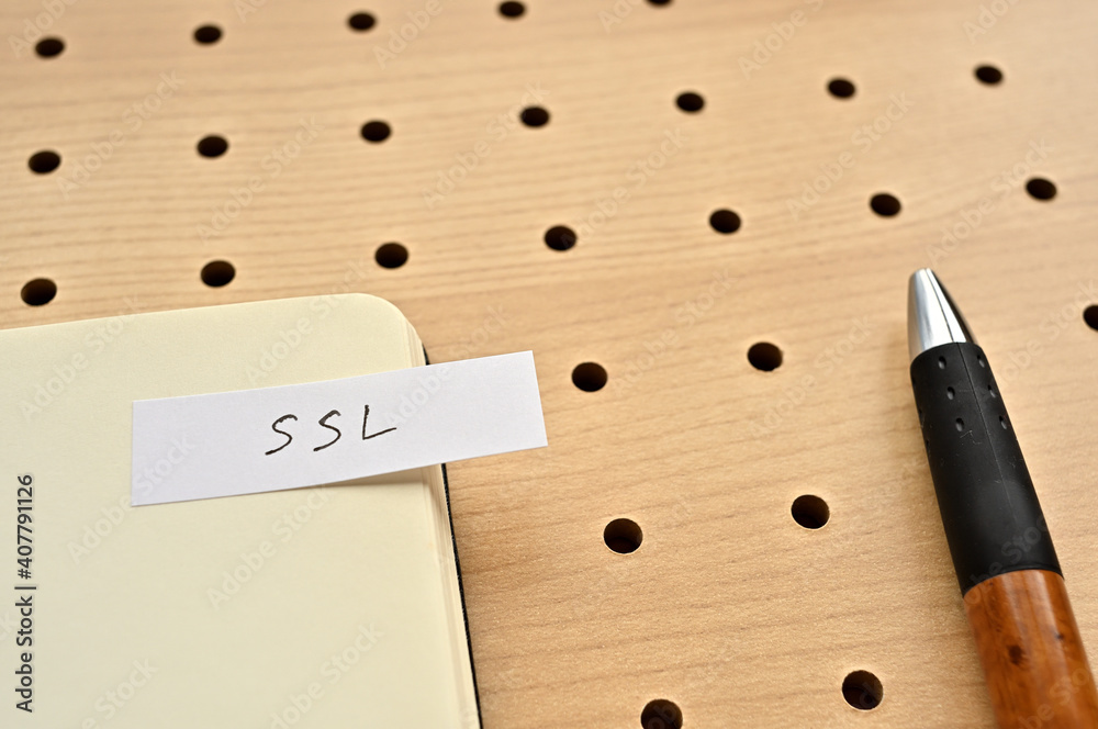 Poster a sticky note with ssl written on the edge of an open notebook on the punching board. that's an acro